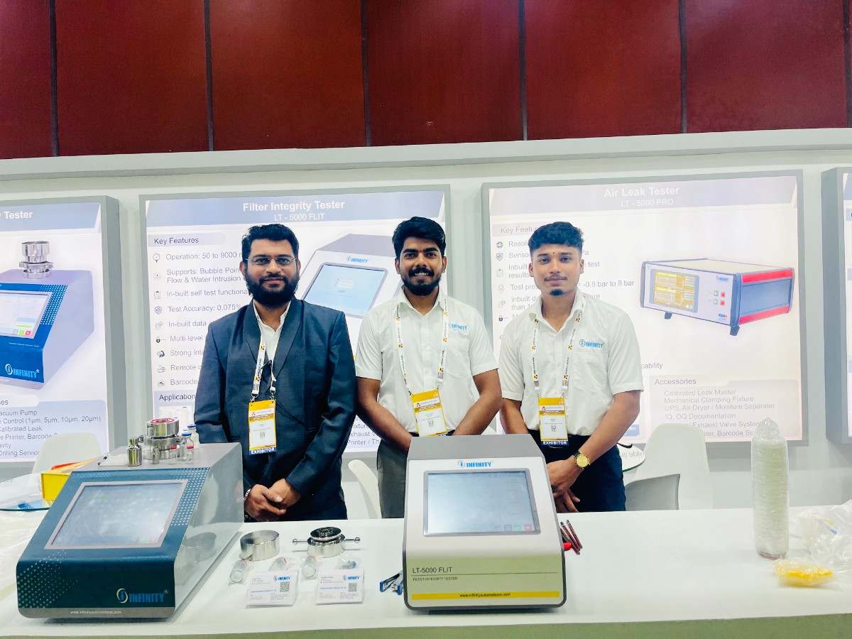 Infinity Automation Systems team showcasing testing equipment at Analytica Lab India 2026 Hyderabad