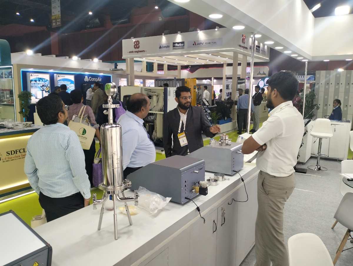 Infinity Automation Systems team demonstrating testing equipment at Analytica Lab India 2026 Hyderabad